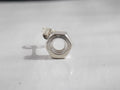 A solid silver nut earring sits on a white background